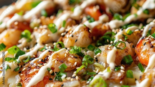 Close-up of okonomiyaki with seafood, cabbage, and pork, garnished with green onions, sesame seeds, and a drizzle of mayo and savory sauce