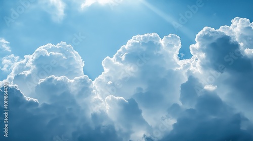 Close-up of puffy white clouds drifting across a bright blue sky photo