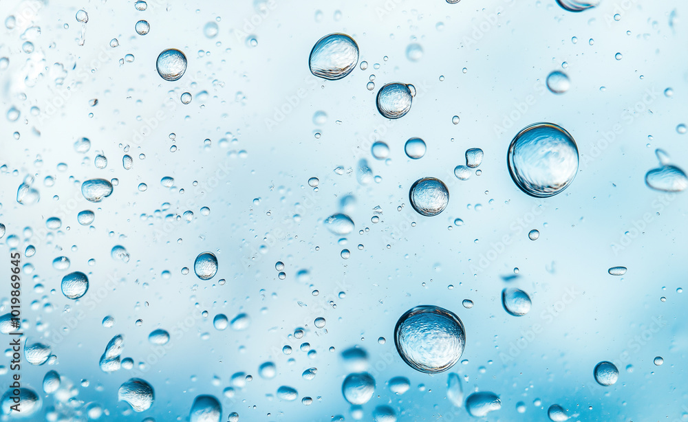 Close-up of water droplets suspended in clear blue liquid. Close-up of water droplets suspended in clear blue liquid.