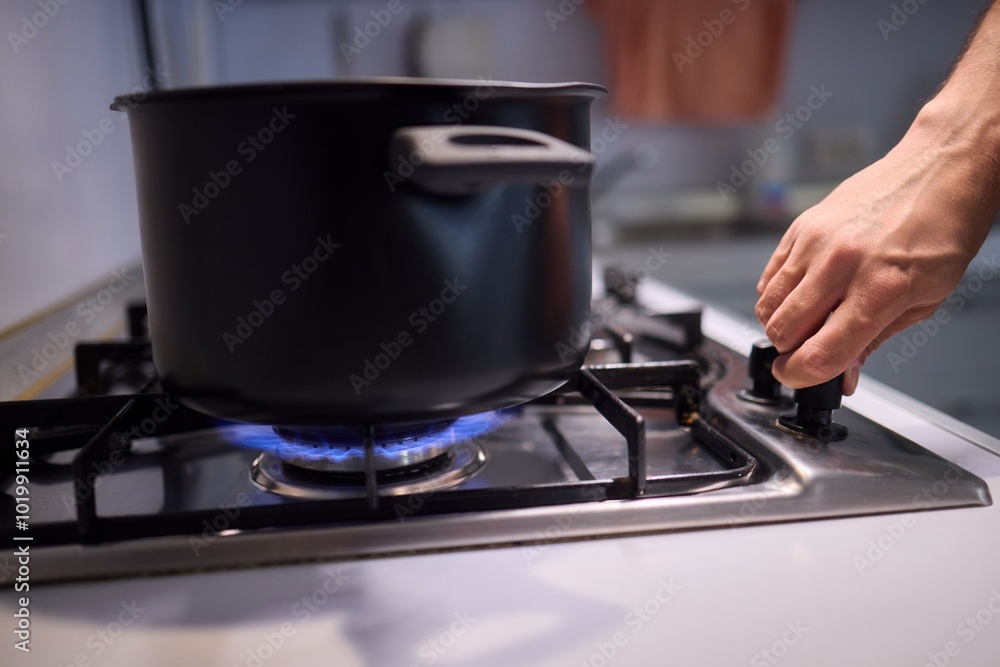 Cooking delicious meals on a modern gas stove using a sleek black pot is an art Cooking delicious meals on a modern gas stove using a sleek black pot is an art