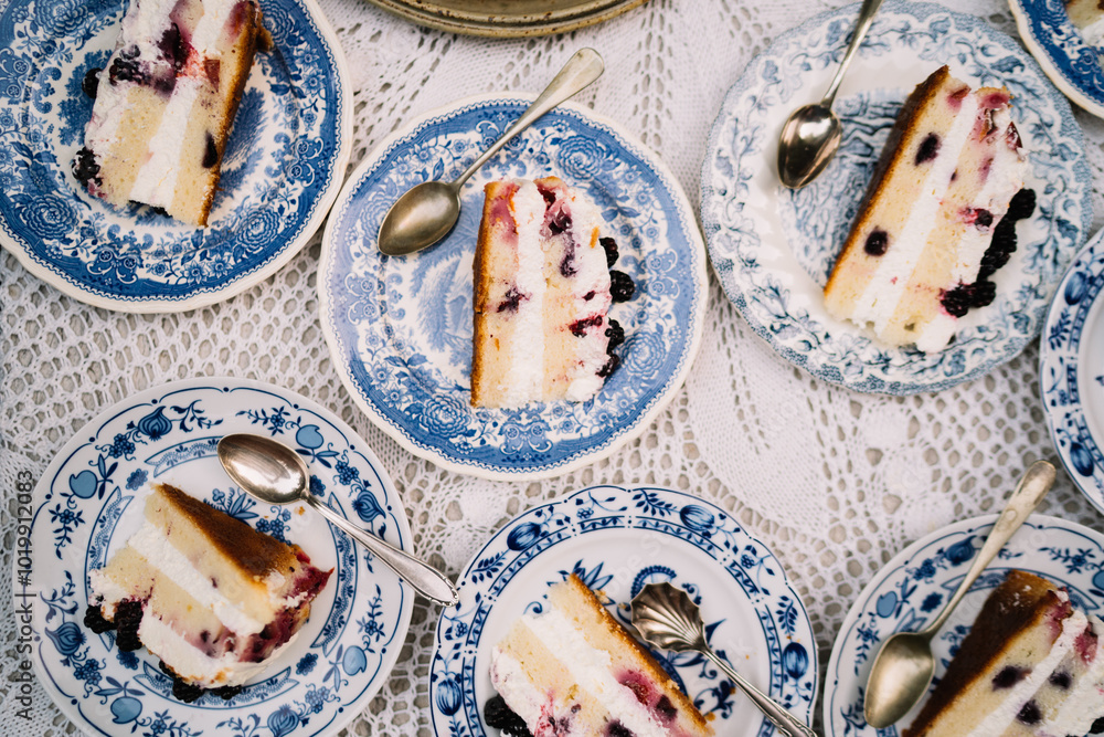 Close-up of berry cake slices on blue-patterned plates Close-up of berry cake slices on blue-patterned plates