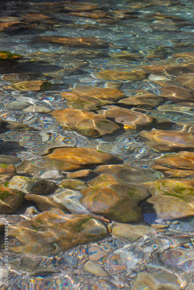 Clear Water Flowing Over Colorful Stones Clear Water Flowing Over Colorful Stones