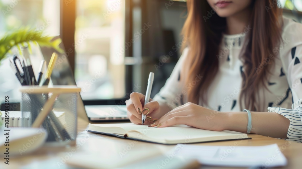 Woman Writing in Notebook at Desk - Focus and Inspiration Woman Writing in Notebook at Desk - Focus and Inspiration