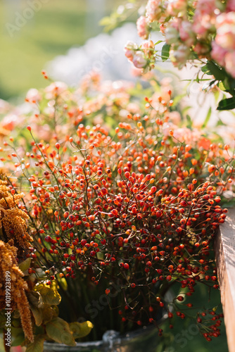 Bunch of vibrant red berries with floral accents. photo