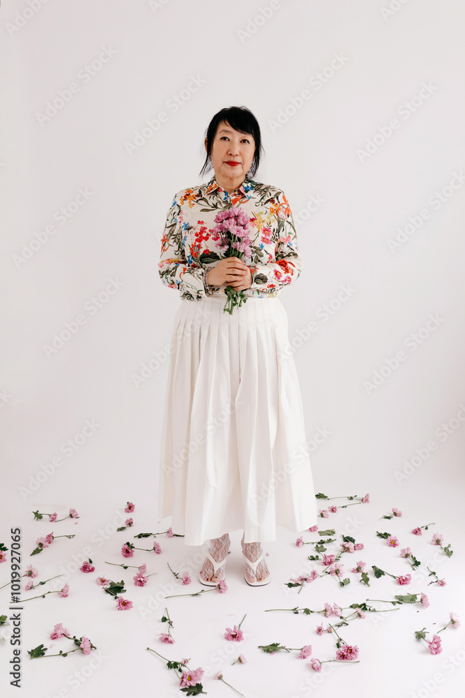 Happy woman with bouquet of flowers in studio Happy woman with bouquet of flowers in studio