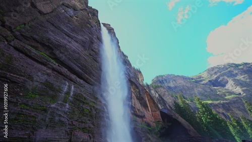 Telluride Bridal Veil Falls wide close up Waterfall Telluride Black Bear Pass Road Colorado powerplant windy mist spray Ouray Ridgway Box Canyon cliffside 4wd hiking cloudy sun blue sky slow pan down photo