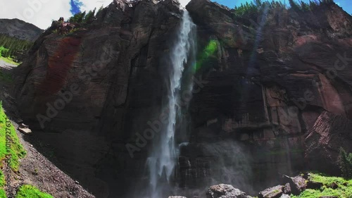 Summer green Telluride Bridal Veil Falls Waterfall Colorado powerplant house aerial drone Box Canyon Black Bear Pass Road Rocky Mountains 4wd hiking blue sky cliffs Uncompahgre Forest pan down motion photo