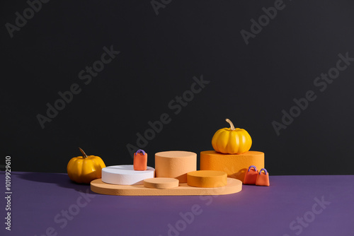 Minimalist Halloween Podium Display with Pumpkins and Bags photo