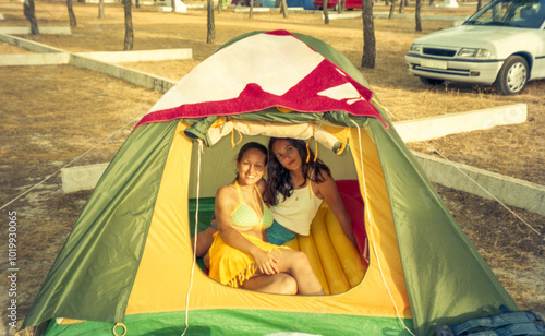 analog film image of two sisters in a tent photo