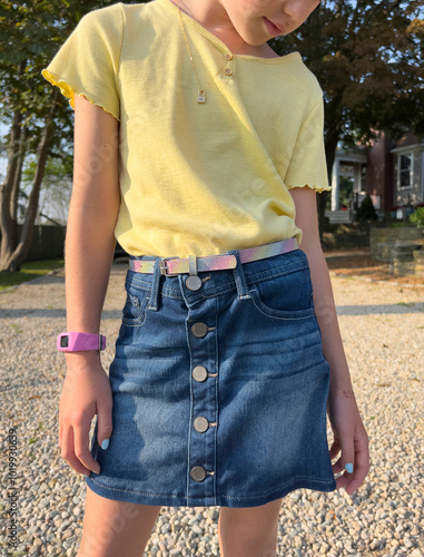 Young Girl is first day of school fashion outfit with skirt  