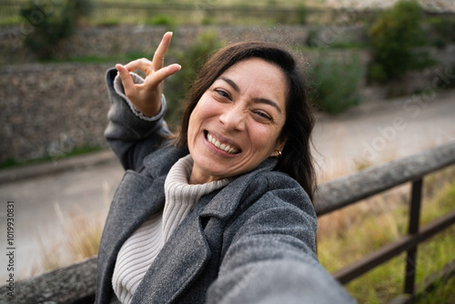 A business woman smiling while taking a selfie photo