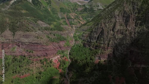 Telluride Yankee Boy Basin Colorado Black Bear Pass Road Box Canyon Rocky Mountains dirt road 4wd hiking blue sky cliffside valley aerial drone Ouray Ridgway summer Aspen Forest forward pan up motion photo