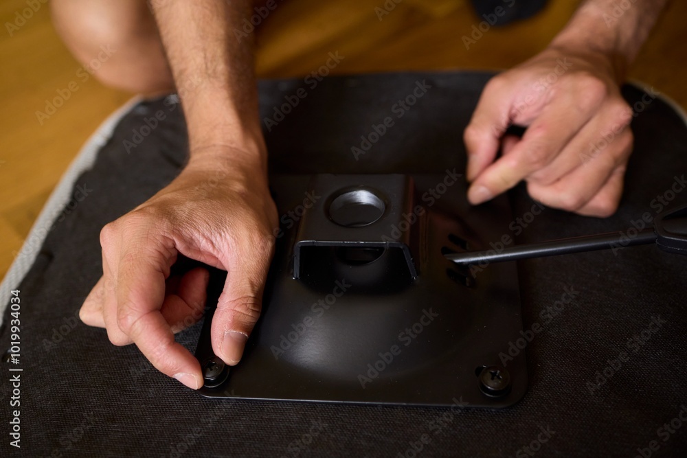 A Young Man Assembling a Stylish Modern Chair in a Comfortable Minimalist Interior Space A Young Man Assembling a Stylish Modern Chair in a Comfortable Minimalist Interior Space