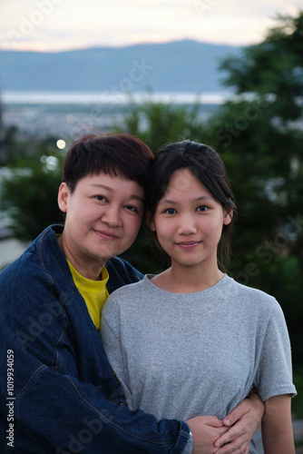 Portrait of Chinese mother and daughter on balcony in the evening photo