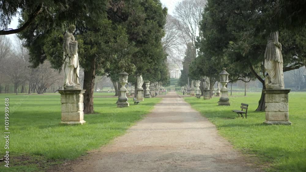 The main avenue of Querini park with its typical ornamental statues and sculptures in Vicenza, Italy. The main avenue of Querini park with its typical ornamental statues and sculptures in Vicenza, Italy.