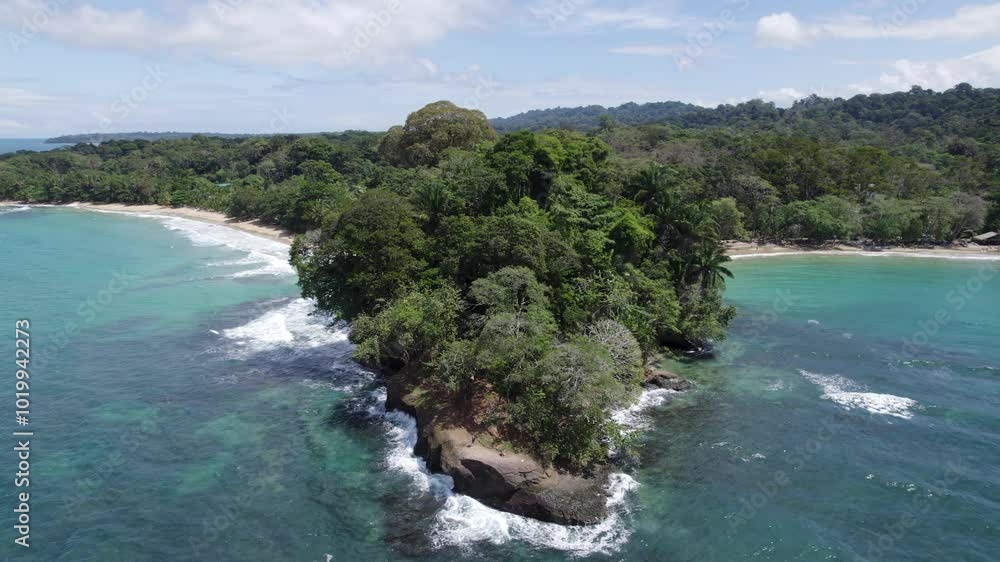 Aerial view of Punta Uva's lush tropical forest meeting the vibrant turquoise coastline in Costa Rica. Circle Dolly Shot Aerial view of Punta Uva's lush tropical forest meeting the vibrant turquoise coastline in Costa Rica. Circle Dolly Shot