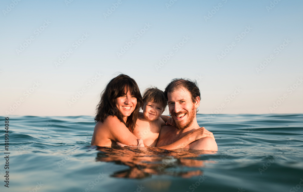 Happy parents and baby in the sea Happy parents and baby in the sea