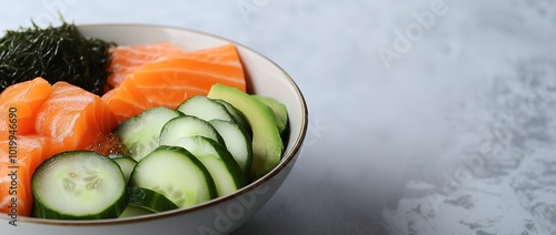 Fresh deconstructed sushi bowl with salmon and cucumber photo