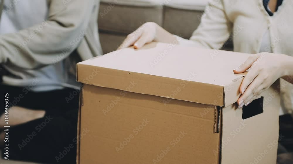 Young Asian couple relocating to a new house, joyfully packing and unpacking belongings. Expertise in moving, packing, togetherness, and creating a new home together. Young Asian couple relocating to a new house, joyfully packing and unpacking belongings. Expertise in moving, packing, togetherness, and creating a new home together.
