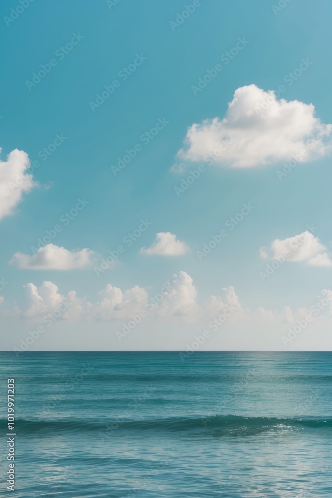 Calm turquoise sea with fluffy clouds under blue sky. Calm turquoise sea with fluffy clouds under blue sky.