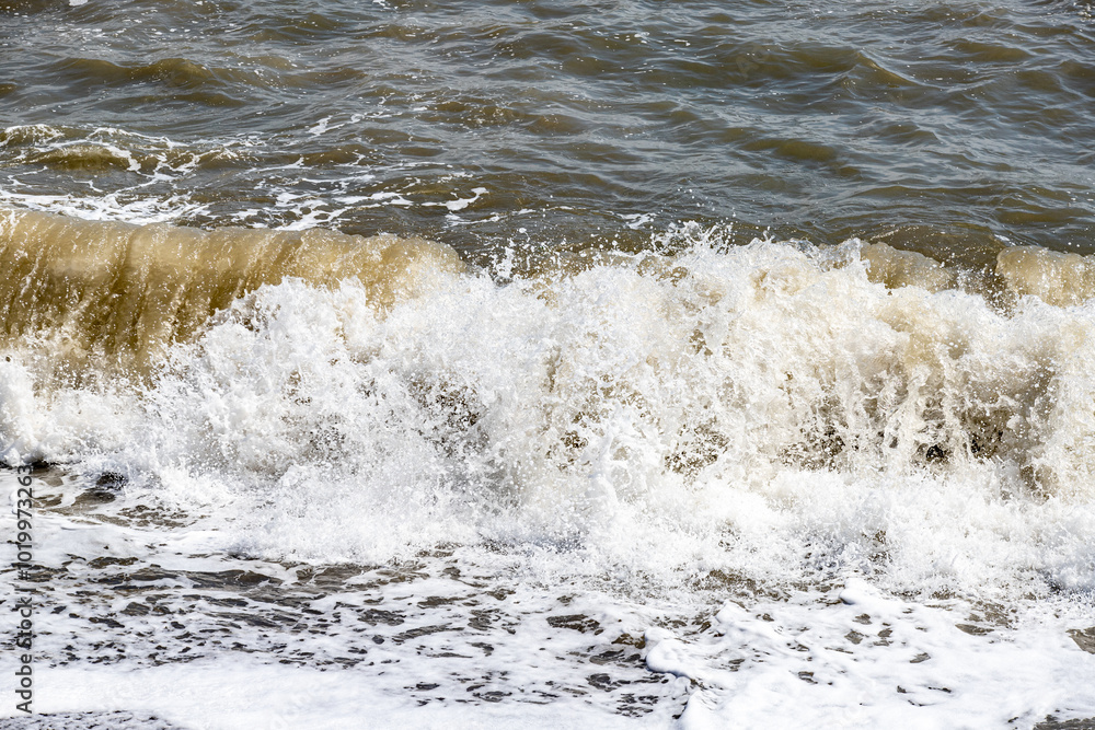 foamy coastal sea wave of a pebble beach foamy coastal sea wave of a pebble beach