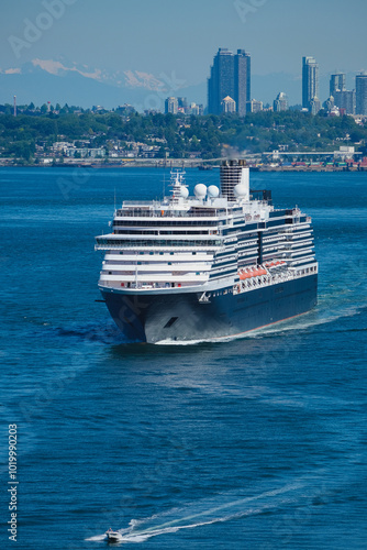 Modern cruiseship cruise ship ocean liner Noordam sail away departure from port of Vancouver, British Columbia for Alaska summer cruising on sunny day with city skyline Mount Rainier photo