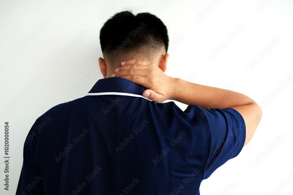 Tired young asian business man suffering neck and hand pain while working for so long at home, exhausted man rubbing and massaging his painful area and frowning, suffering osteoporosis or arthritis Tired young asian business man suffering neck and hand pain while working for so long at home, exhausted man rubbing and massaging his painful area and frowning, suffering osteoporosis or arthritis