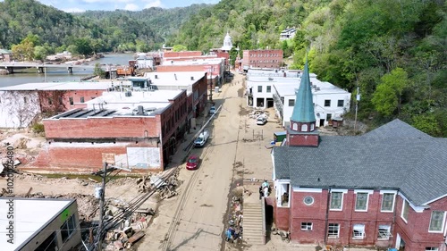 Aerial video over destruction and clean up of downtown Marshall, NC, 1 week after tropical storm Helene flooding.