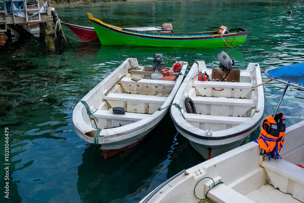 Tourist and divers boat at the dock in Rubiah Island Sumatera, Indonesia. Two fishing boats at the harbour in Sabang Island. Tourist and divers boat at the dock in Rubiah Island Sumatera, Indonesia. Two fishing boats at the harbour in Sabang Island.