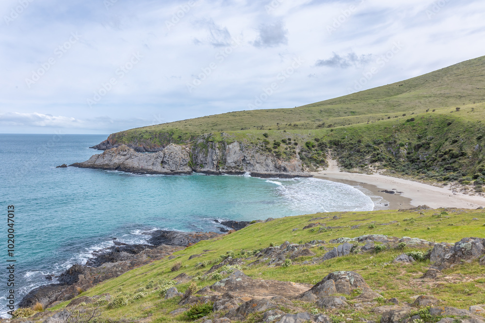 Beautiful Blowhole Beach, an idyllic cove between two steep sided headlands with aquamarine sea under an overcast sky in Deep Creek Conservation Park on the Fleurieu Peninsula in South Australia. Beautiful Blowhole Beach, an idyllic cove between two steep sided headlands with aquamarine sea under an overcast sky in Deep Creek Conservation Park on the Fleurieu Peninsula in South Australia.