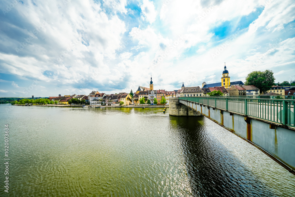 Obraz premium View of the Main and the Old Main Bridge in Kitzingen. Medieval stone bridge of the city.