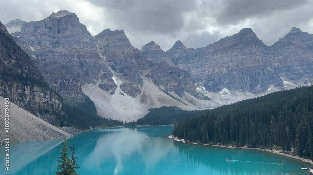 Boats sailing on blue-green waters of Moraine Lake, Banff, Canada. Handheld Boats sailing on blue-green waters of Moraine Lake, Banff, Canada. Handheld