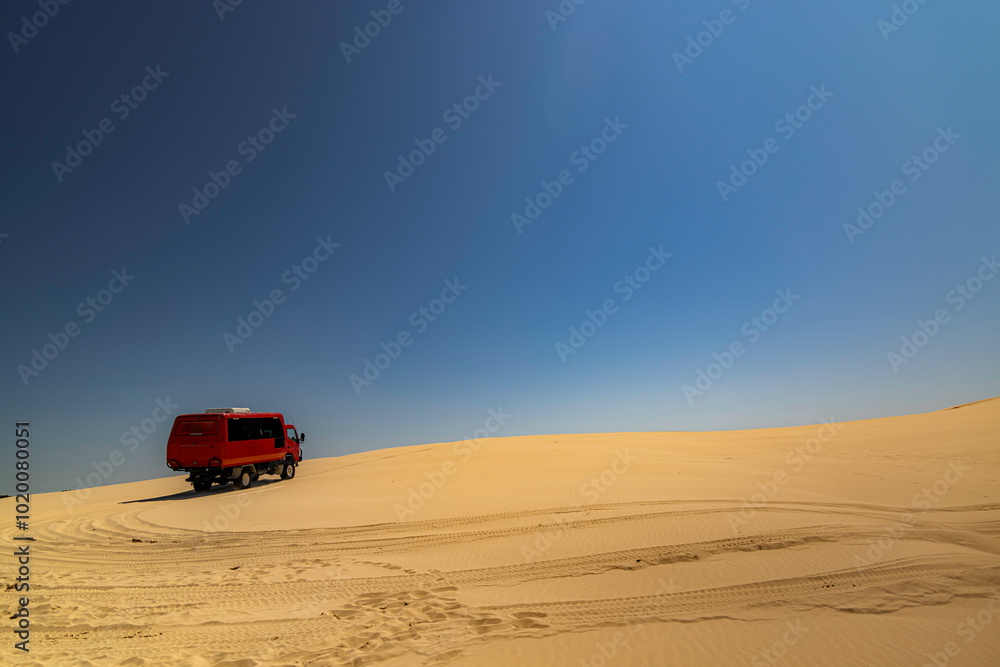 Desert sanddunes with foot tracks and blue sky Desert sanddunes with foot tracks and blue sky