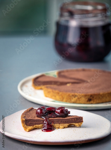 Slice of Chocolate Pie with Whole Pie And Jar of Cherries photo