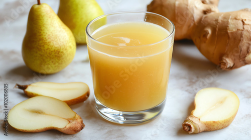 A glass of fresh pear and ginger juice surrounded by whole and sliced pears and ginger roots, showcasing vibrant colors and natural ingredients. photo