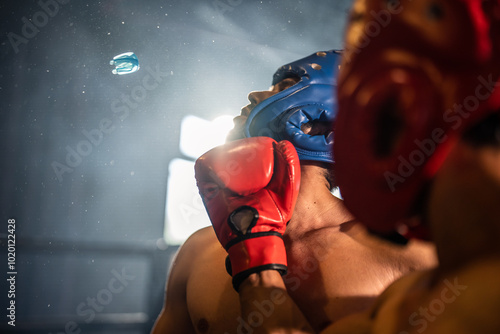 Two young professional boxer having a competition tournament on stage. photo