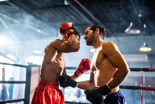 Two young professional boxer having a competition tournament on stage. photo