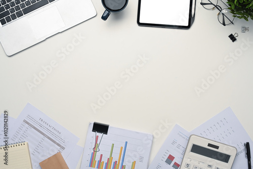 Top view digital tablet with empty display, laptop and financial document on white table photo