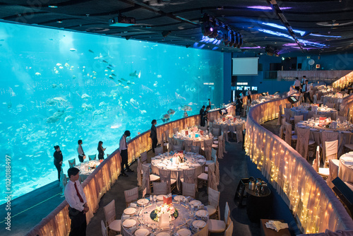 luxury color theme wedding solemnisation dinner flower florist , dinnerware banquet, cloth and stage lighting decoration design in premium hotel ballroom and beautiful beach event