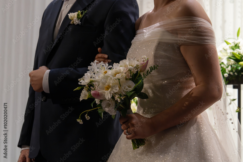 bride and groom with bouquet in the wedding hall