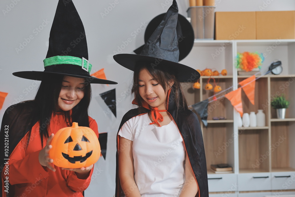 Fototapeta premium friendship, holiday and people concept - group of happy smiling friends in halloween costumes of vampire, devil, witch and cheetah at home party