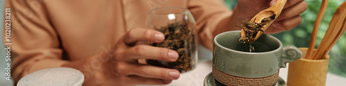 Canvas Print Header with man brewing herbal tea at home