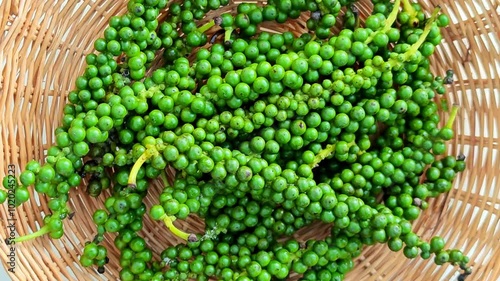 Peppercorn berries rotation on basket photo