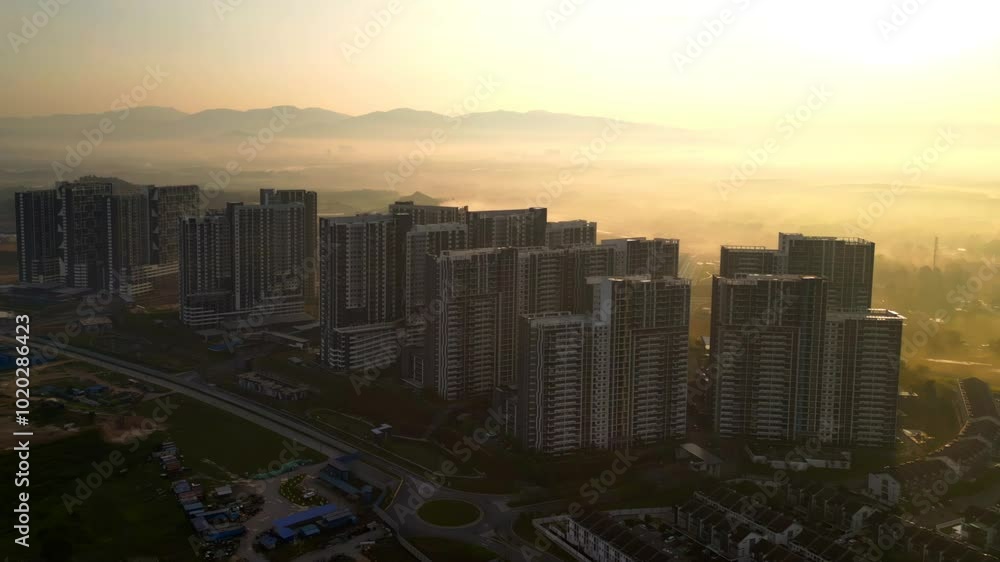 Moving up aerial view during Golden sunrise near apartment area in Bangi Avenue, Selangor, Malaysia. Moving up aerial view during Golden sunrise near apartment area in Bangi Avenue, Selangor, Malaysia.