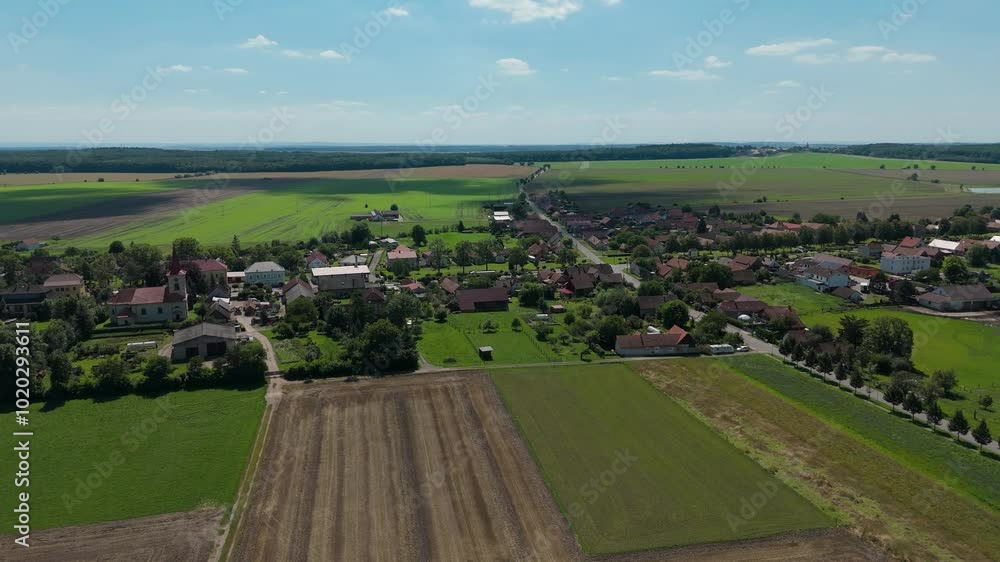 Flying around a czech village Luzec nad Cidlinou on a sunny day with fields and meadows around Flying around a czech village Luzec nad Cidlinou on a sunny day with fields and meadows around