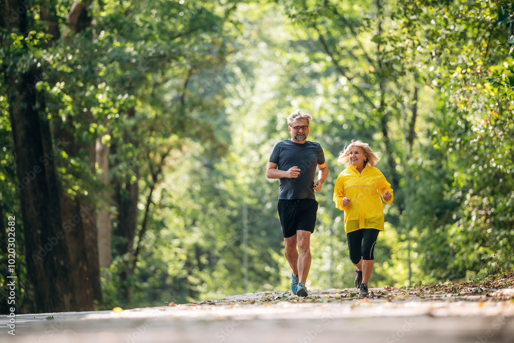 Casual jogging, sport conception. Senior couple together outdoors at nature Casual jogging, sport conception. Senior couple together outdoors at nature