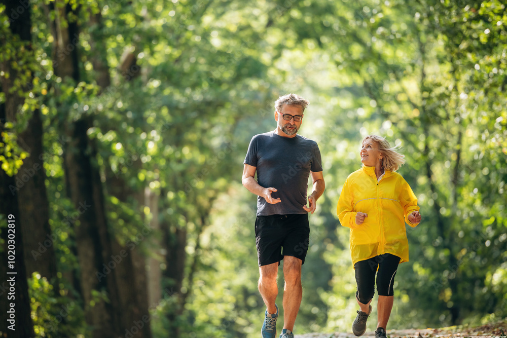 Obraz premium Casual jogging, sport conception. Senior couple together outdoors at nature