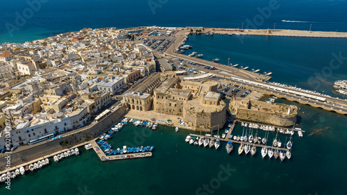 Aerial view of Gallipoli Castle, almost completely surrounded by the Ionian Sea, in Salento, Puglia, Italy. The fortress stands at the end of the island where the historic center is located.