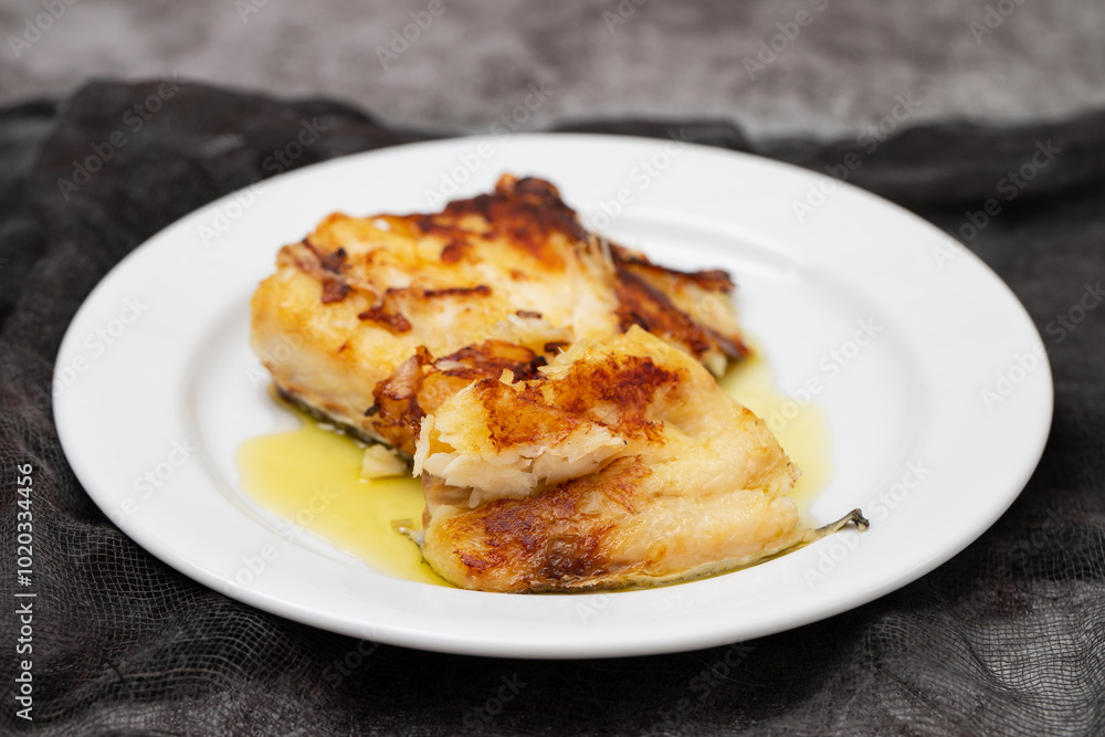 fried cod fish with olive oil on white dish fried cod fish with olive oil on white dish