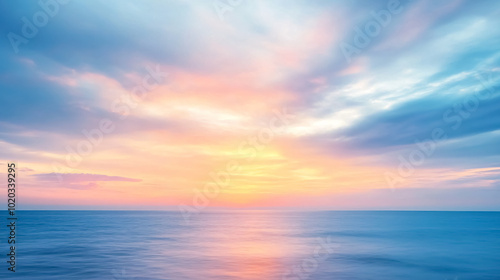 Abstract Blurred Sunrise Sky and Ocean Nature Background: An abstract image featuring a blurred sunrise sky over the ocean, creating a dreamy and serene background.